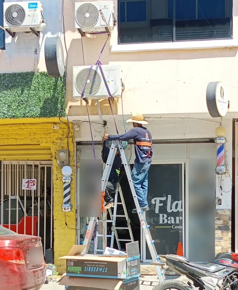Técnicos de Alvarado Solutions instalando un aire acondicionado split en un local comercial de La Aurora